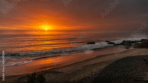 Fototapeta Naklejka Na Ścianę i Meble -  Sunrise with a moody sky over beach
