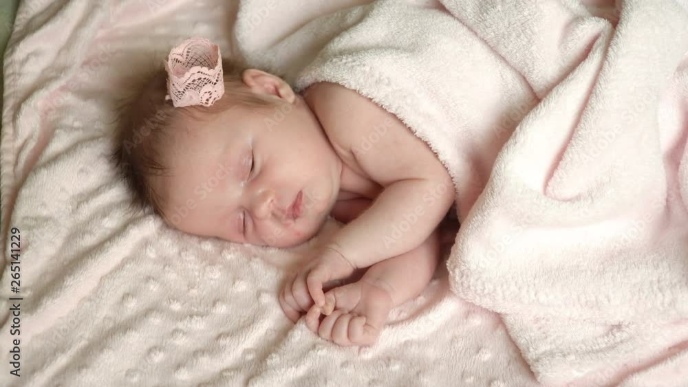Close up of newborn little baby girl is sleeping on the bed, sweet dreams of little baby, healthy sleep. 4k video 25 fps Close up of newborn little baby girl is sleeping on the bed, sweet dreams of little baby, healthy sleep. 4k video 25 fps