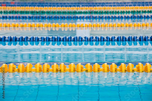 The Surface Of The Pool With Blue Water And Yellow And Blue Dividers Of Swimming Tracks