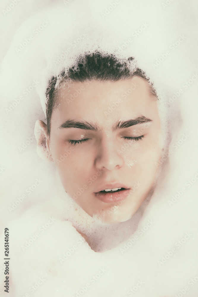 Attractive man in the bath with foam. Attractive man in the bath with foam.