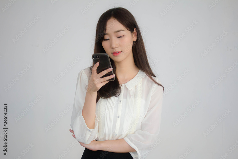 portrait of thai china adult office girl white shirt using her smart phone portrait of thai china adult office girl white shirt using her smart phone