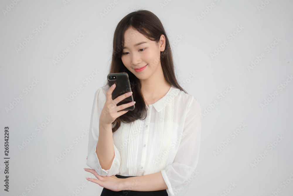 portrait of thai china adult office girl white shirt using her smart phone portrait of thai china adult office girl white shirt using her smart phone