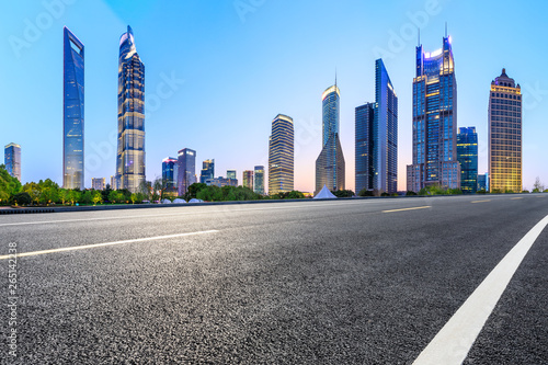 Shanghai modern commercial office buildings and empty asphalt road at night,panoramic view
