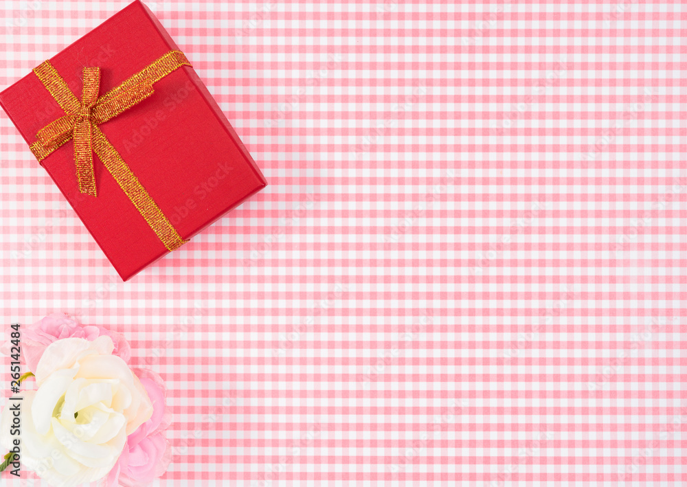 gift box with red isolated on Plaid background. Holiday decoration for Mother's Day or Women's Day. gift box with red isolated on Plaid background. Holiday decoration for Mother's Day or Women's Day.