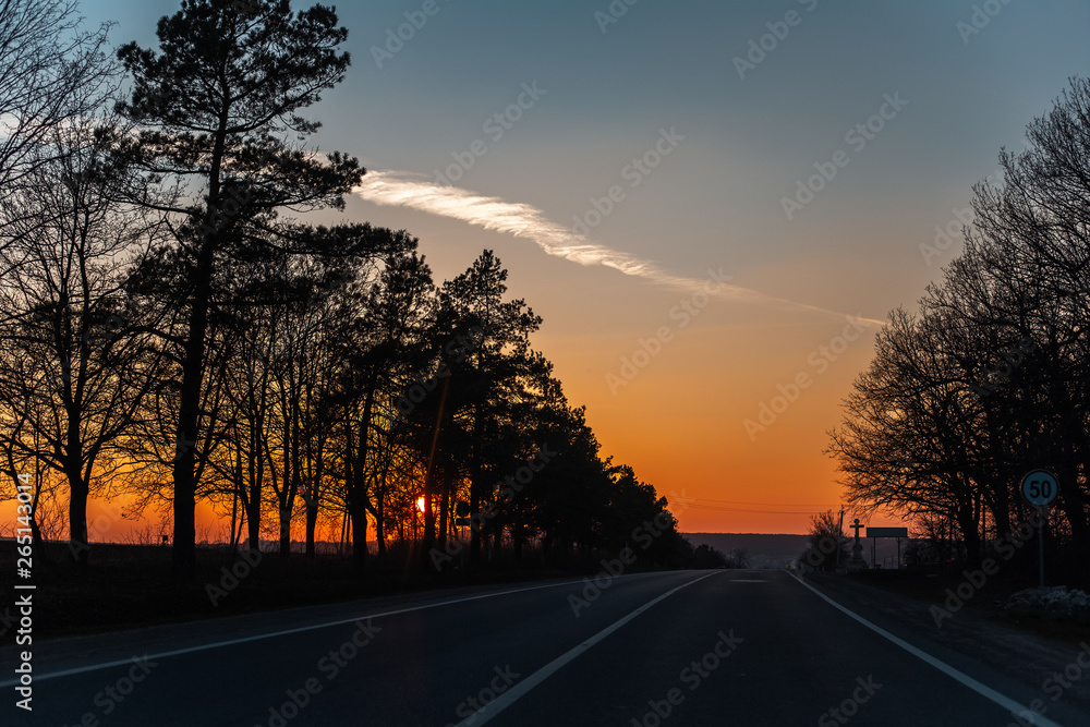 Fototapeta premium Landscape of unreal natural sunset on road from inside of car.