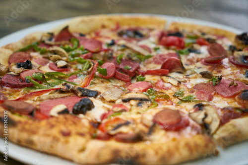 Delicious pizza served on porcelain plate