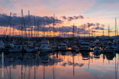 Colorful sunset over Coffs Harbour marina with yachts and boats © Olga K