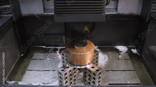 An electronic discharge machining bath filling with dielectric fluid.