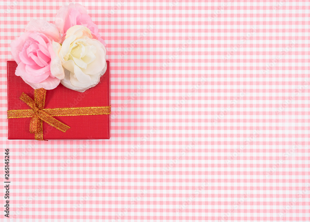 gift box with red isolated on Plaid background. Holiday decoration for Mother's Day or Women's Day. gift box with red isolated on Plaid background. Holiday decoration for Mother's Day or Women's Day.