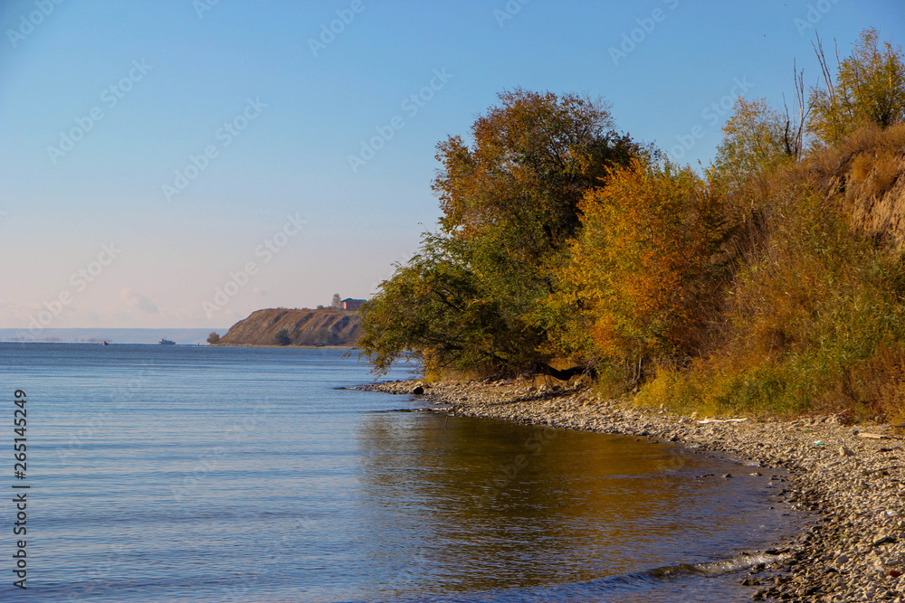 The nature of the earth. Steppe, field and road. Deserted shore, cliff on the banks of the river. Trees Autumn. Cool. Daytime.