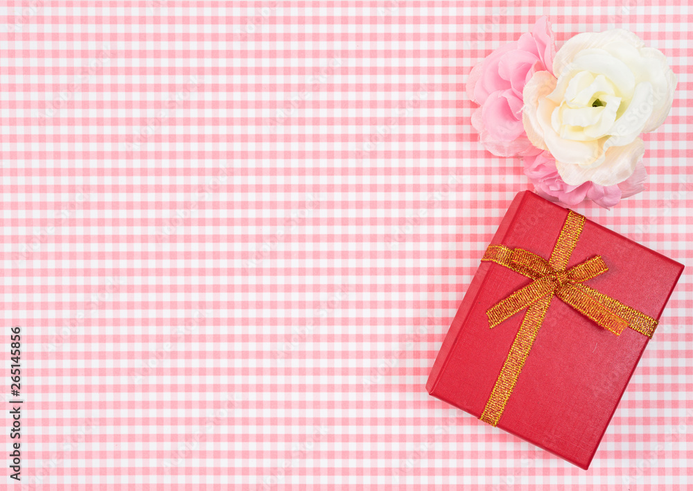 gift box with red isolated on Plaid background. Holiday decoration for Mother's Day or Women's Day. gift box with red isolated on Plaid background. Holiday decoration for Mother's Day or Women's Day.