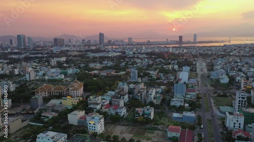 Wallpaper Mural A drone view of Danang, Vietnam flying toward downtown skyscrapers, cityscape and the Han River during sunset. Torontodigital.ca
