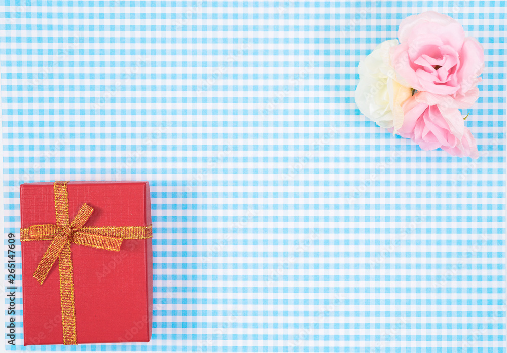 gift box with red isolated on Plaid background. Holiday decoration for Mother's Day or Women's Day. gift box with red isolated on Plaid background. Holiday decoration for Mother's Day or Women's Day.