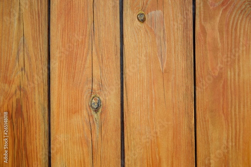 Wooden surface, texture. The natural color of pine planks is covered with clear varnish. A fence from the tightly nailed wooden planks. Close-up. Selective focus. Copy space. 
