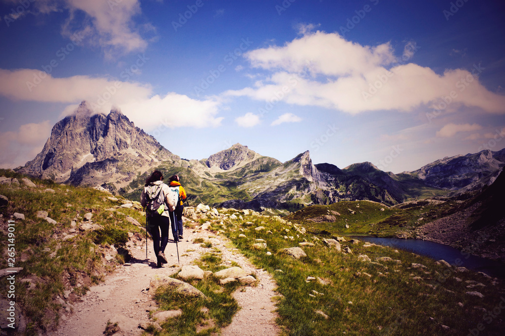 two hiker in front of the Midi d'Ossau and in the Ayous Lakes, Pyrenees, France