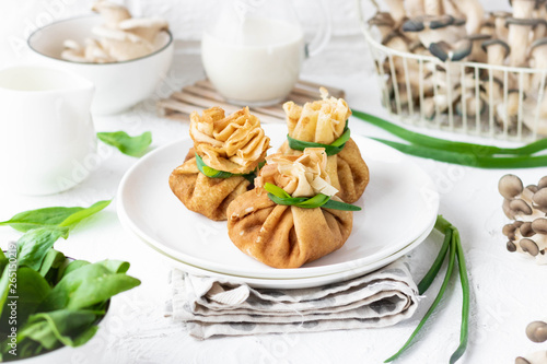 Pancake bags stuffed with with fried oyster mushrooms with spinach