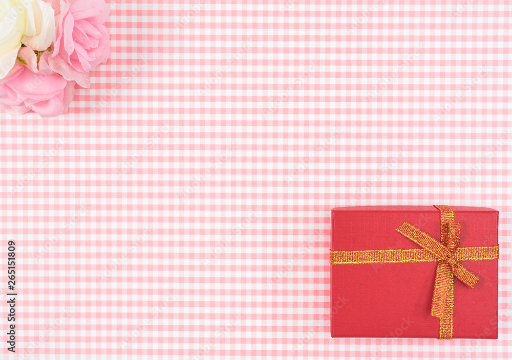 gift box with red isolated on Plaid background. Holiday decoration for Mother's Day or Women's Day. gift box with red isolated on Plaid background. Holiday decoration for Mother's Day or Women's Day.