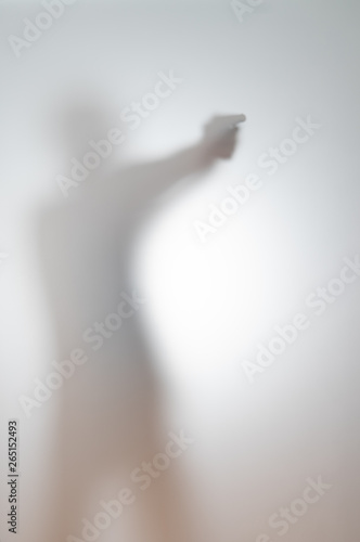 blurred silhouette of a man with a gun