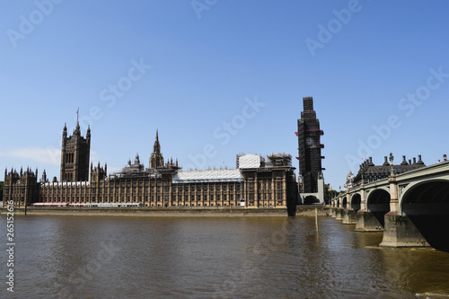 House of the parliament , westminster palace and big ben under renovation with a bridge presenting the reality of modern cities with brown tinted colors and dirty look.