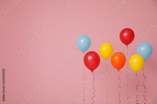 Slika na platnu Bright balloons on color background, space for text