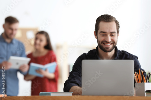 Male student with laptop do...