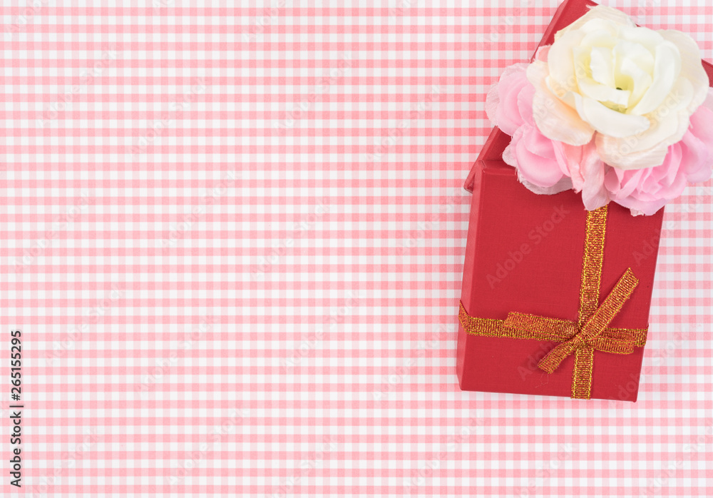 gift box with red isolated on Plaid background. Holiday decoration for Mother's Day or Women's Day. gift box with red isolated on Plaid background. Holiday decoration for Mother's Day or Women's Day.