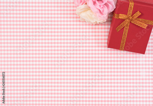 gift box with red isolated on Plaid background. Holiday decoration for Mother's Day or Women's Day. © yaophotograph