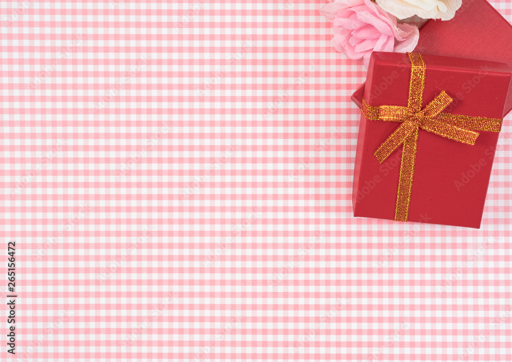 gift box with red isolated on Plaid background. Holiday decoration for Mother's Day or Women's Day.