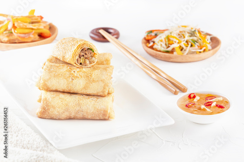 Traditional Chinese tortillas filled - bings in a plate on a white background, salads, Dam Sam snacks.