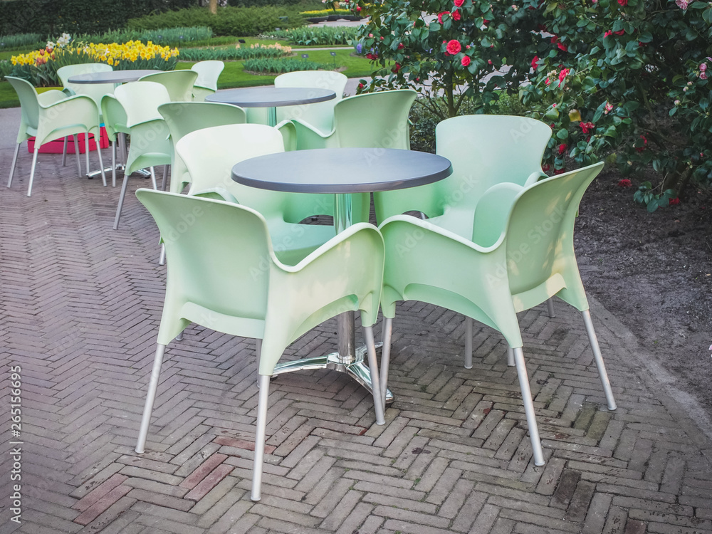 Spring garden with outdoor furniture on the terrace of a cafe in the Netherlands. The concept of rest.