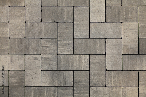 Paving slabs of gray blocks regular shape close-up. New pavement in the city park