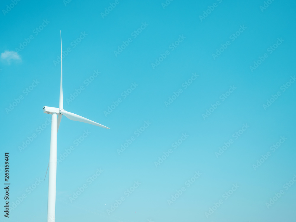 earth day and renewable energy concept with one white wind turbine and beauty sky in summer background earth day and renewable energy concept with one white wind turbine and beauty sky in summer background