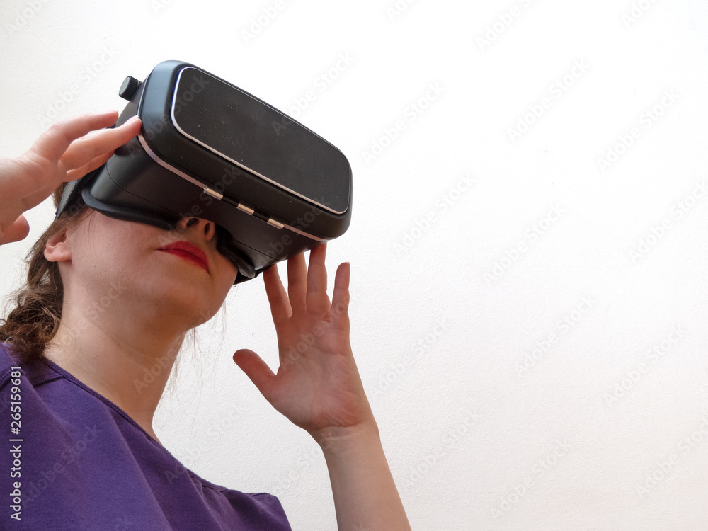 Young woman wearing virtual reality headset isolated on white background Young woman wearing virtual reality headset isolated on white background