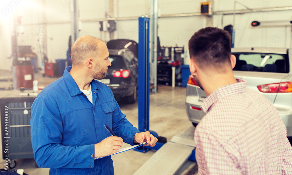 auto service, repair, maintenance and people concept - mechanic with clipboard and man or owner at car shop