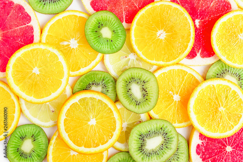 citrus slices - kiwi  oranges and grapefruits on white background. Fruits backdrop