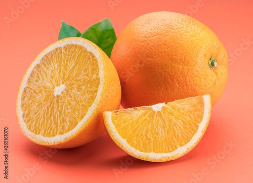 Fototapeta Naklejka Na Ścianę i Meble -  Orange fruit with orange slices and leaves isolated on orange background.