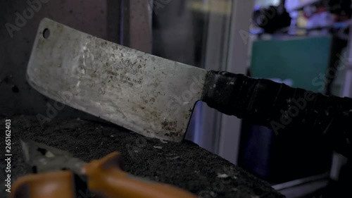 chopping hatchet for seafood, fish, squid, lobster, bloody hatchet stuck in the stump, street fish market
