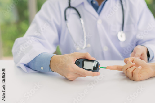 Obraz na plátně checking blood sugar level from patient hand