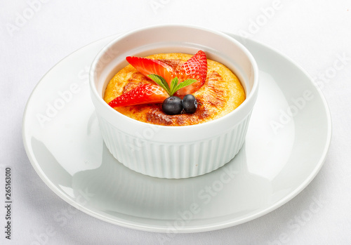 Baked cottage cheese dessert with strawberry on white background