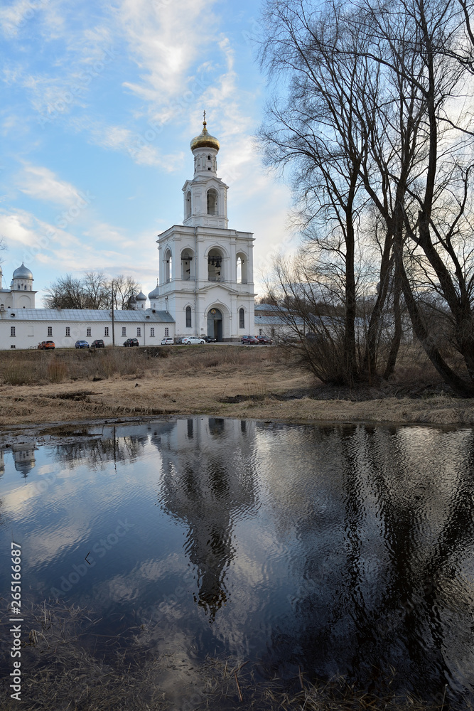Spring view of the Yurievsky Monastery with reflection in the water. Great Novgorod
