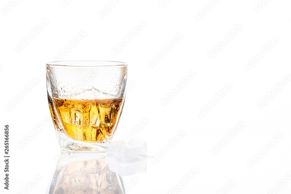 The glass of whisky on white background. Side view. Blank space. The glass of whisky on white background. Side view. Blank space.
