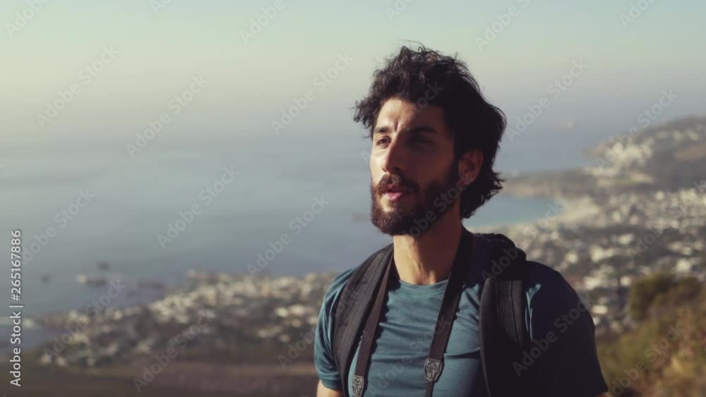 Smiling Male Hiker Looking Away While Dinking Water Against Sky Smiling Male Hiker Looking Away While Dinking Water Against Sky