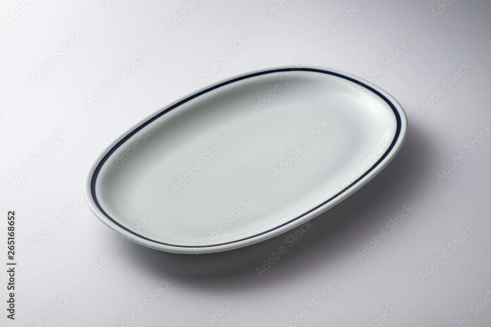 White oval plate with blue line on the edge White oval plate with blue line on the edge