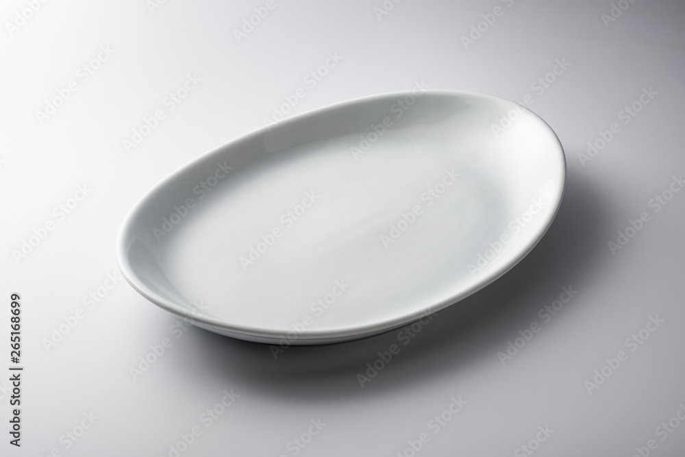 Isolated empty white oval plate Isolated empty white oval plate