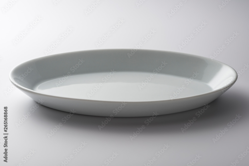 Isolated empty white oval plate Isolated empty white oval plate
