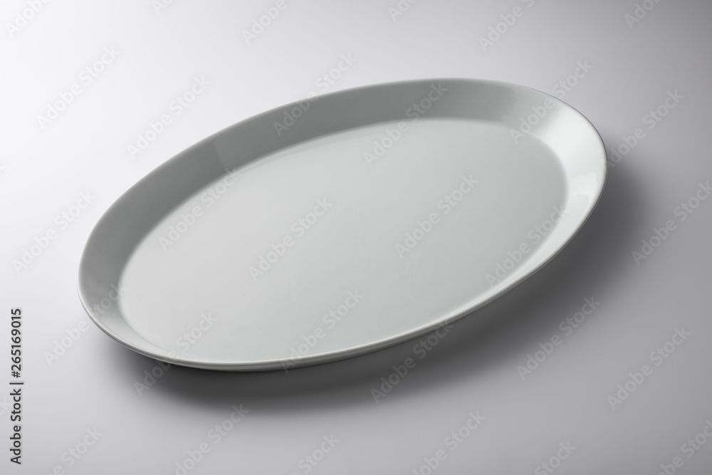Isolated empty white oval plate Isolated empty white oval plate