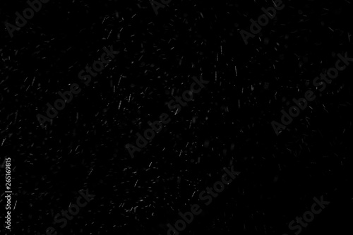 Abstract real dust floating over black background
