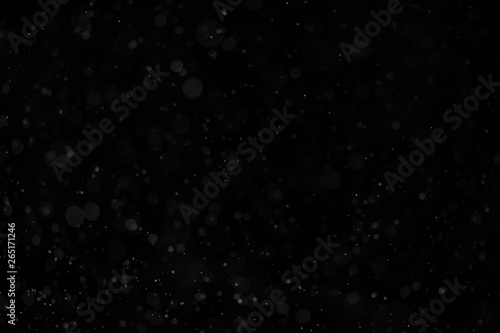 Abstract real dust floating over black background