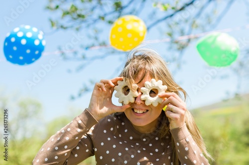 Woman making fun - glasses from home made cakes