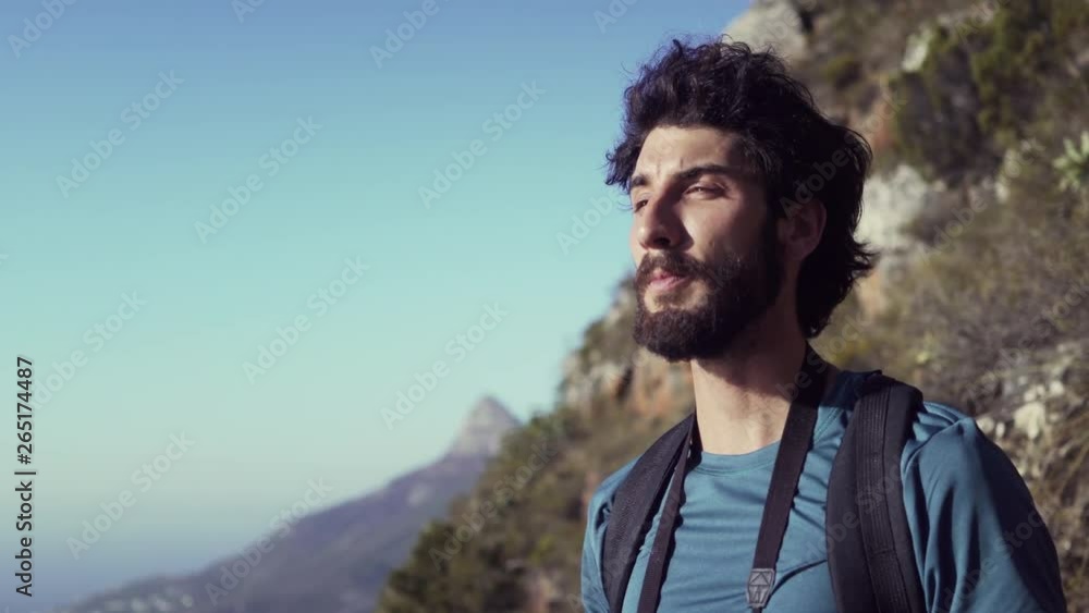 Happy Hiker Drinking Water While Standing On Mountain Against Sky Happy Hiker Drinking Water While Standing On Mountain Against Sky